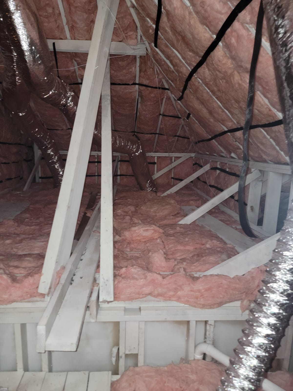 Attic space after wood treatment and paint and after installation of r-38 batt insulation after cleaning